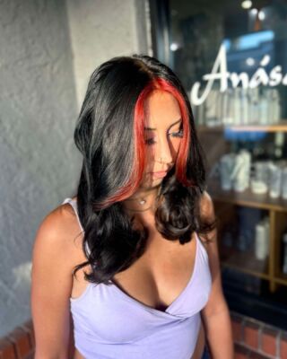 Loving this gorgeous transformation by Jenna! 🌟 Black hair with a bold red money piece is the ultimate combo. Who's ready for a change?  #HairInspo #RedHot #SalonStyle #temeculasalon #temeculahair #anasahairstudio